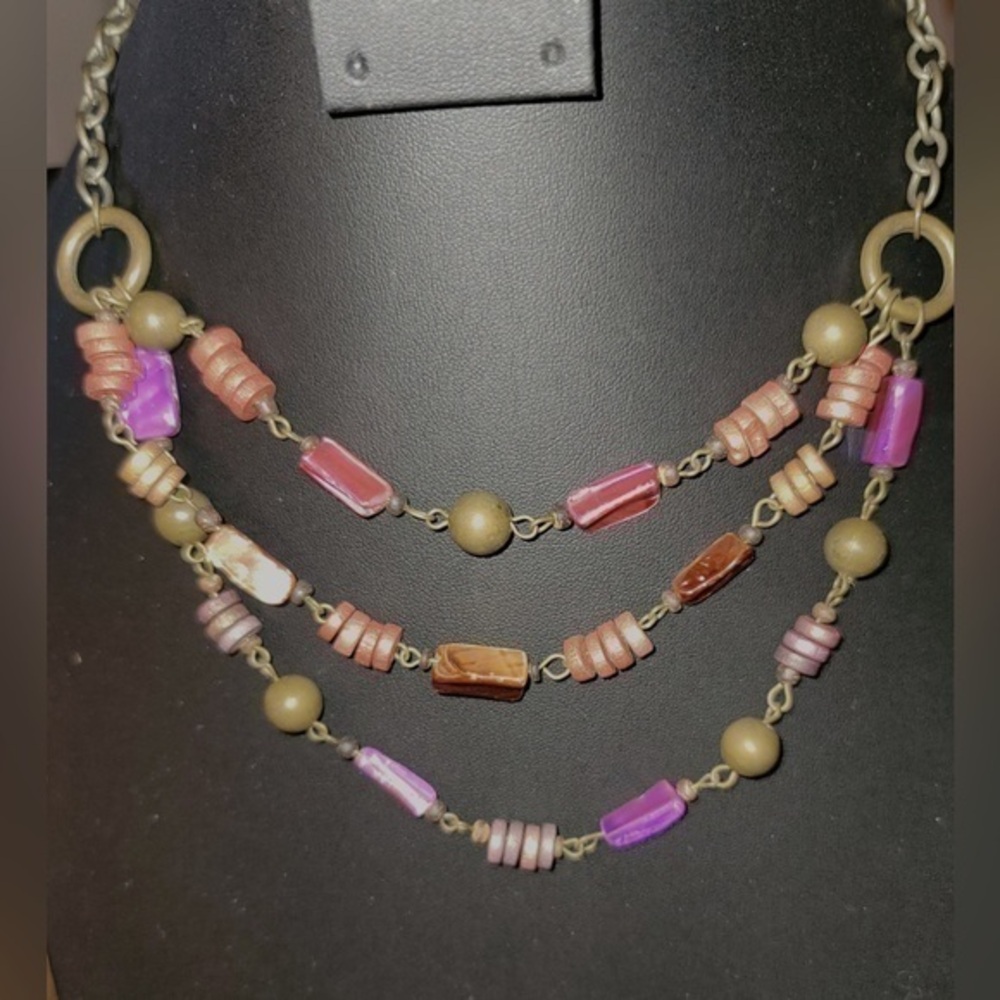 Pink and purple beaded necklace. Likely wooden / stone beads.